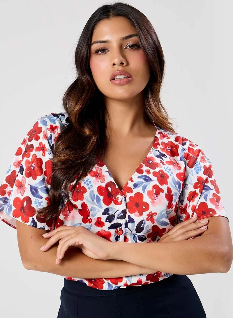 زجزاج بلوزة حمراء بطبعة وأكمام واسعة بفتحة رقبة على شكل